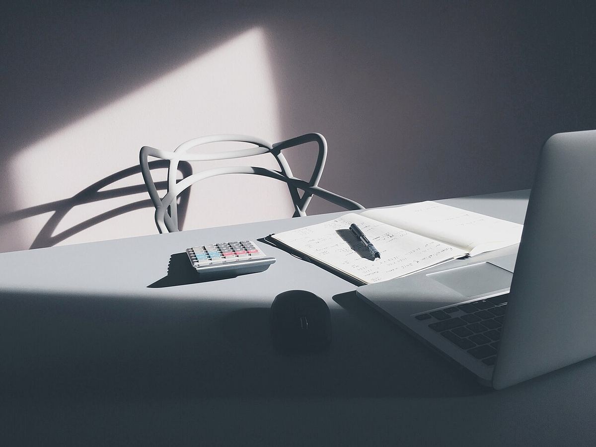 Laptop and calculator on a desk for looking up z-table probabilities